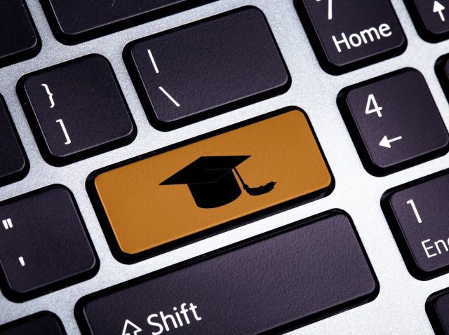 Bottom on a Laptop with Graduate Hat - Close Up